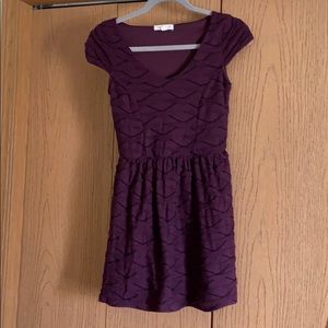 Purple mini dress with short sleeves.